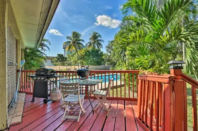 a deck with a table and chairs and a grill at Quaint Central Miami Bungalow 10 Mi to Mid-Beach! in Miami