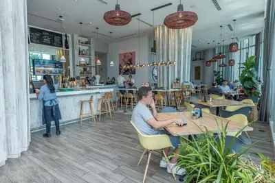 a man sitting at a table in a restaurant at Hyde Beach House Luxury Condo-Resort 2808 condo in Hollywood Beach