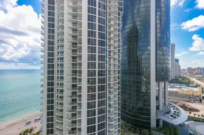 an aerial view of two tall buildings next to the beach at 2 BR Luxury Suite in Marenas Beach Resort 2508 condo in Miami Beach