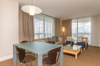 a living room with a table and a couch at 2 BR Luxury Suite in Marenas Beach Resort 2508 condo in Miami Beach