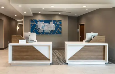 a lobby with two counters and a painting on the wall at Holiday Inn Express Miami Airport-Blue Lagoon Area by IHG in Miami