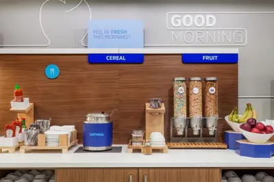 a kitchen with a counter with food on it at Holiday Inn Express Miami Airport-Blue Lagoon Area by IHG in Miami