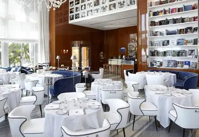 a dining room with white tables and white chairs at ICON BRICKELL-29th FLOOR OCEAN VIEWS-FREE SPA in Miami