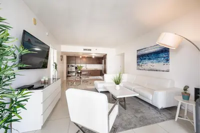 a living room with a white couch and a tv at ICON BRICKELL-29th FLOOR OCEAN VIEWS-FREE SPA in Miami