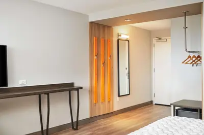 a bedroom with a bed and a mirror at Tru By Hilton Ft Lauderdale Airport in Dania Beach