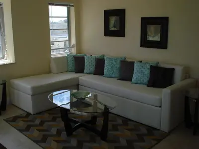 a living room with a couch and a glass table at Westover Arms Hotel in Miami Beach