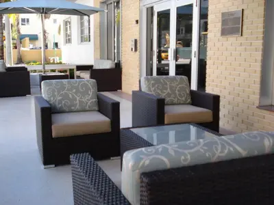 a group of chairs and tables on a patio at Westover Arms Hotel in Miami Beach