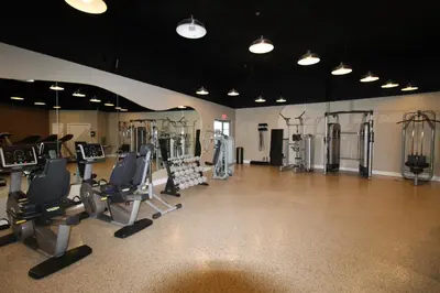 a gym with several treadmills and exercise machines at Castle 1733 Ocean view studio with direct beach access, pool, tennis & free parking in Miami Beach