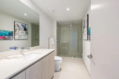 a white bathroom with a sink and a toilet at Family 3 bedroom Hyde Beach House Miami 22th floor in Hallandale Beach