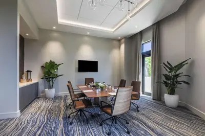a dining room with a table and chairs at THesis Hotel Miami Coral Gables, Curio Collection by Hilton in Miami