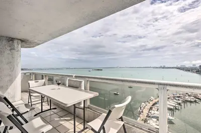 a balcony with a table and chairs and a view of the water at Waterfront High-Rise Condo - Miami Beach 5 Mi in Miami