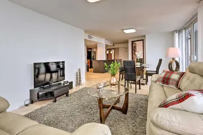 a living room with a couch and a tv and a table at Waterfront High-Rise Condo - Miami Beach 5 Mi in Miami