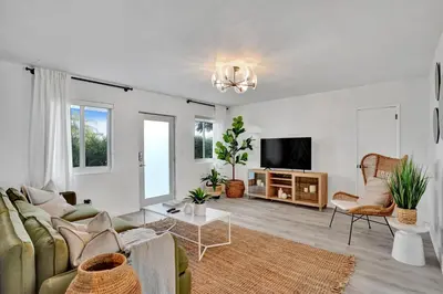 a living room with a couch and a tv at Lincoln Villa Suites in Miami Beach
