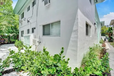 a white house with plants in front of it at Lincoln Villa Suites in Miami Beach