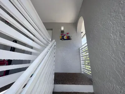 a staircase with white railings in a house at Stylish Studio Apartment By Miami International Airport in Miami