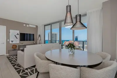 a living room with a table and chairs at Luxury with stunning view, Balcony, Amazing Pools in Hollywood