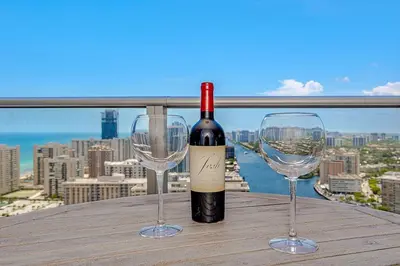 a bottle of wine and two wine glasses on a table at Luxury with stunning view, Balcony, Amazing Pools in Hollywood