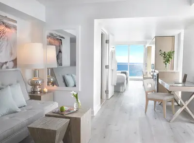 a living room with a white couch and a table at Grand Beach Hotel Surfside in Miami Beach