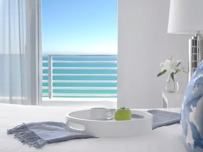 a bowl with an apple in it on a bed at Grand Beach Hotel Surfside in Miami Beach