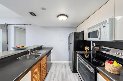 a kitchen with a sink and a microwave at South Beach Suites in Ocean Drive in Miami Beach