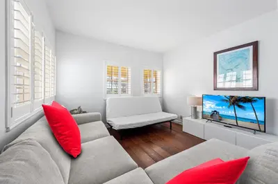 a living room with a couch and red pillows at South Beach Suites in Ocean Drive in Miami Beach