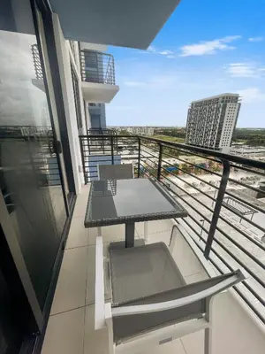 a balcony with a table and chairs on a building at Provident Grand Luxury Short-Term Residences in Miami