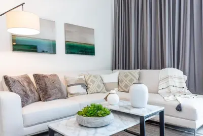 a living room with a white couch and a table at Penthouse 2 Terraces Ocean Views Beach Access in Hollywood