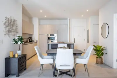 a kitchen and dining room with a table and chairs at Penthouse 2 Terraces Ocean Views Beach Access in Hollywood