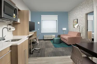a hotel room with a kitchen and a living room at Home2 Suites By Hilton Miami Doral West Airport, Fl in Miami
