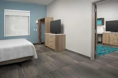 a bedroom with a bed and a flat screen tv at Home2 Suites By Hilton Miami Doral West Airport, Fl in Miami