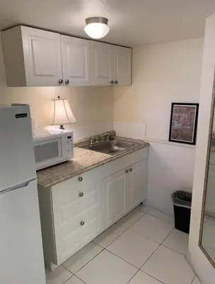 a kitchen with a sink and a microwave at Bposhtels Hollywood Florida in Hollywood