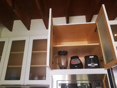 a kitchen with white cabinets and a microwave at LUXURY Guayabita's House in Miami