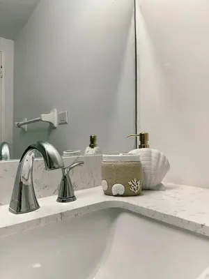 a bathroom counter with a sink and a mirror at Pavilion Beach Front Apartment with Balcony in Miami Beach
