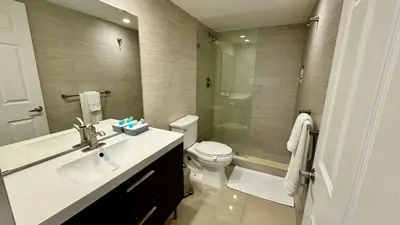 a bathroom with a sink and a toilet and a shower at Sunny Isles, beach life! Parking included in Miami Beach