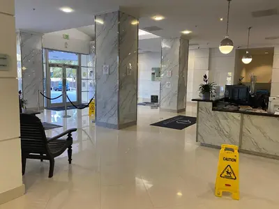 a lobby of a building with a caution sign on the floor at Sunny Isles, beach life! Parking included in Miami Beach