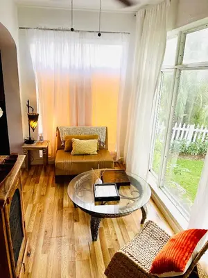 a living room with a couch and a table at Ne Miami Cottage in Miami