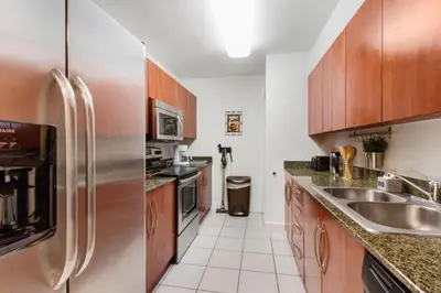 a kitchen with wooden cabinets and stainless steel appliances at Miami Downtown Brickell spacious 4 Bedrooms 6 Beds in Miami
