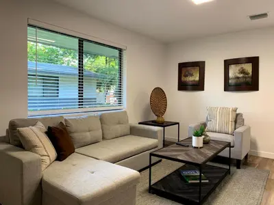 a living room with a couch and a table at Harbourside Flats in Fort Lauderdale