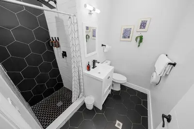 a bathroom with a sink and a toilet and a shower at Nine20 Collins Apartments by Lowkl in Miami Beach
