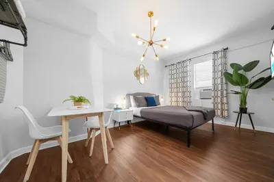 a living room with a bed and a table and chairs at Nine20 Collins Apartments by Lowkl in Miami Beach