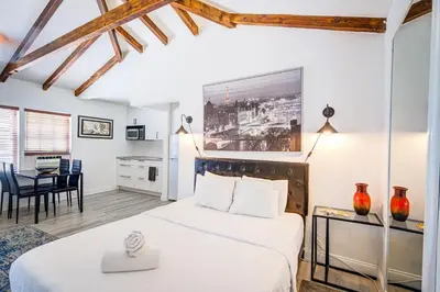 a bedroom with a bed and a table with chairs at Little Paris by the ocean self check in in Fort Lauderdale