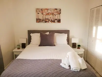 a bedroom with a bed with a stuffed animal on it at Sophisticated Dania Beach Suites Near the Beach in Dania Beach