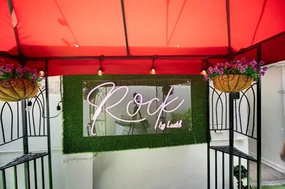 a sign that says rock n roll hanging from a ceiling at Rock Apartments by Lowkl in Miami Beach