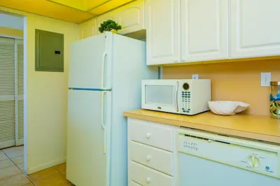 a kitchen with a white refrigerator and a microwave at Sunny Isles Ocean Reserve Condo Apartments - 1BR #812 in Miami Beach