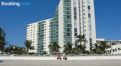 a large building on the beach with people on the beach at Apartamento en la Playa The Tides in Hollywood