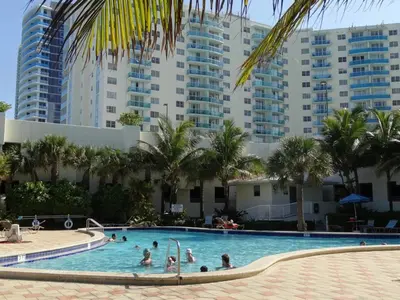 a group of people in a swimming pool with tall buildings at Apartamento en la Playa The Tides in Hollywood