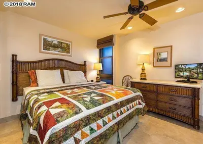 a bedroom with a bed and a ceiling fan at South Maui Condos in Miami Beach