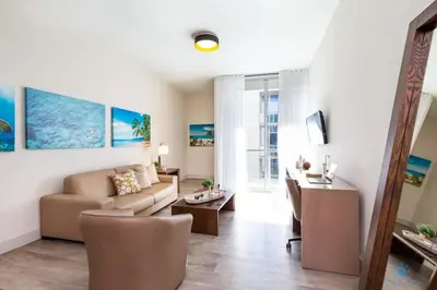 a living room with a couch and a table at Most Liked Home - Rooftop Pool - Hollywood Beach - Gym in Hollywood
