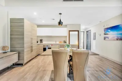 a kitchen with a table and chairs in a room at Apartment with Bay View Balcony - Pool - Up To 6 - Gym in Hollywood