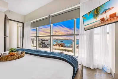 a bedroom with a large window with a view of the ocean at Apartment with Bay View Balcony - Pool - Up To 6 - Gym in Hollywood